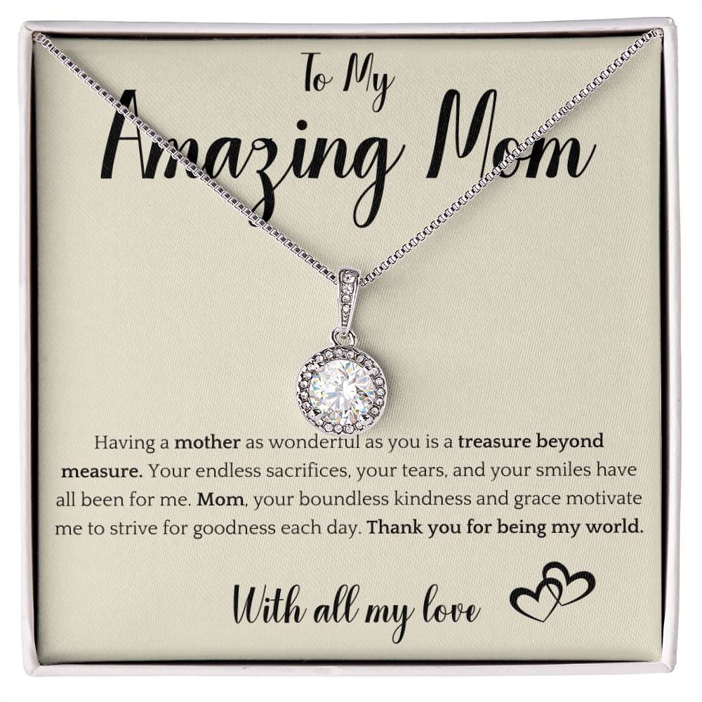 The image shows a card with a silver necklace featuring interlocking rings. The card reads "To My Amazing Mom" at the top, with a heartfelt message below about the mother's sacrifices and kindness. It ends with "With all my love" and a heart illustration.