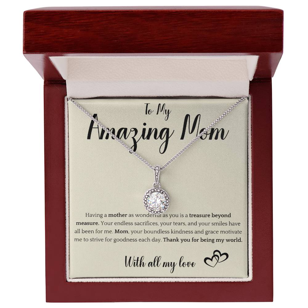 The image shows a card with a silver necklace featuring interlocking rings. The card reads "To My Amazing Mom" at the top, with a heartfelt message below about the mother's sacrifices and kindness. It ends with "With all my love" and a heart illustration.
