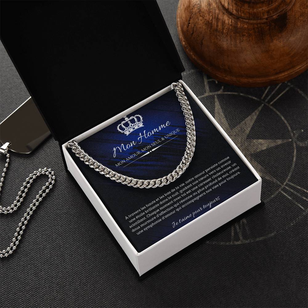 A polished metallic chain necklace on a dark blue and black background with French text detailing a romantic message for my man.