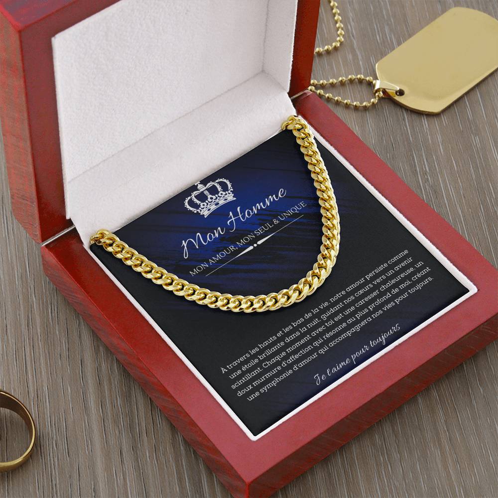 A polished metallic chain necklace on a dark blue and black background with French text detailing a romantic message for my man.