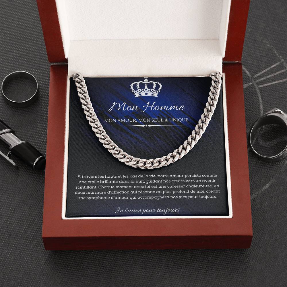 A polished metallic chain necklace on a dark blue and black background with French text detailing a romantic message for my man.