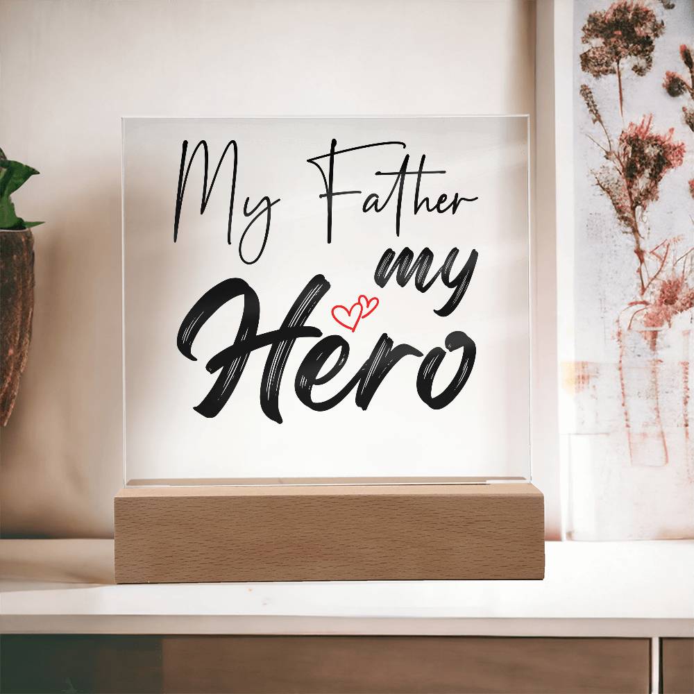 A square glass plaque on a wooden base with text reading "My Father my Hero" and a small red heart design, making it the perfect bestdad gift for Father's Day.