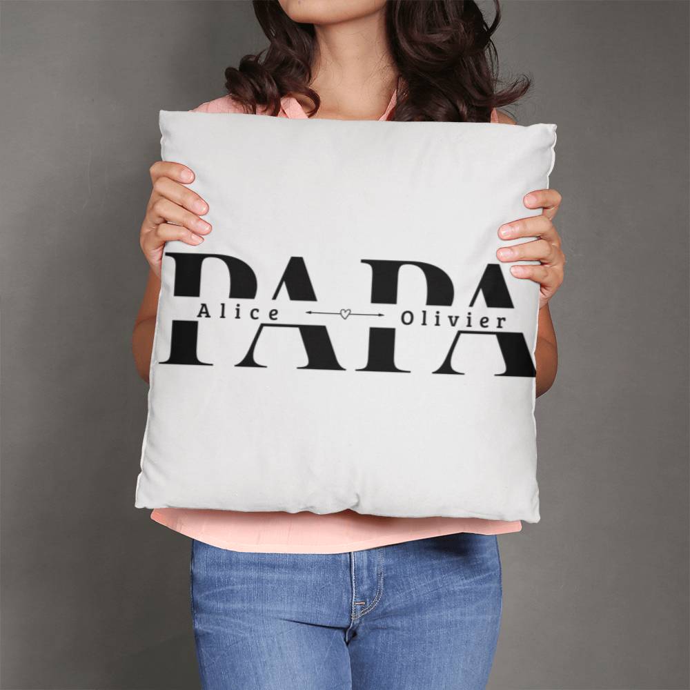a woman holding a pillow with the word papa on it