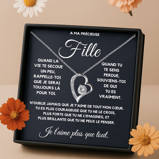 Necklace with heart design on a black plaque with French text, surrounded by flowers.