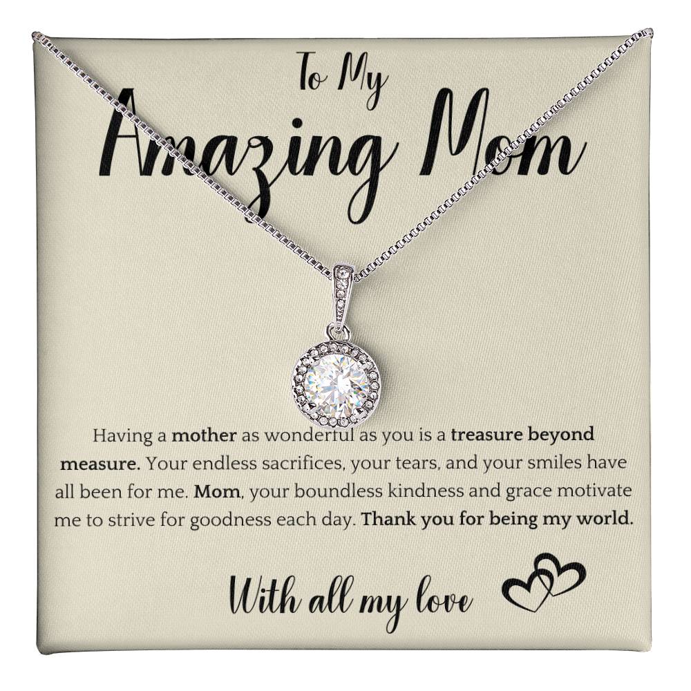 The image shows a card with a silver necklace featuring interlocking rings. The card reads "To My Amazing Mom" at the top, with a heartfelt message below about the mother's sacrifices and kindness. It ends with "With all my love" and a heart illustration.