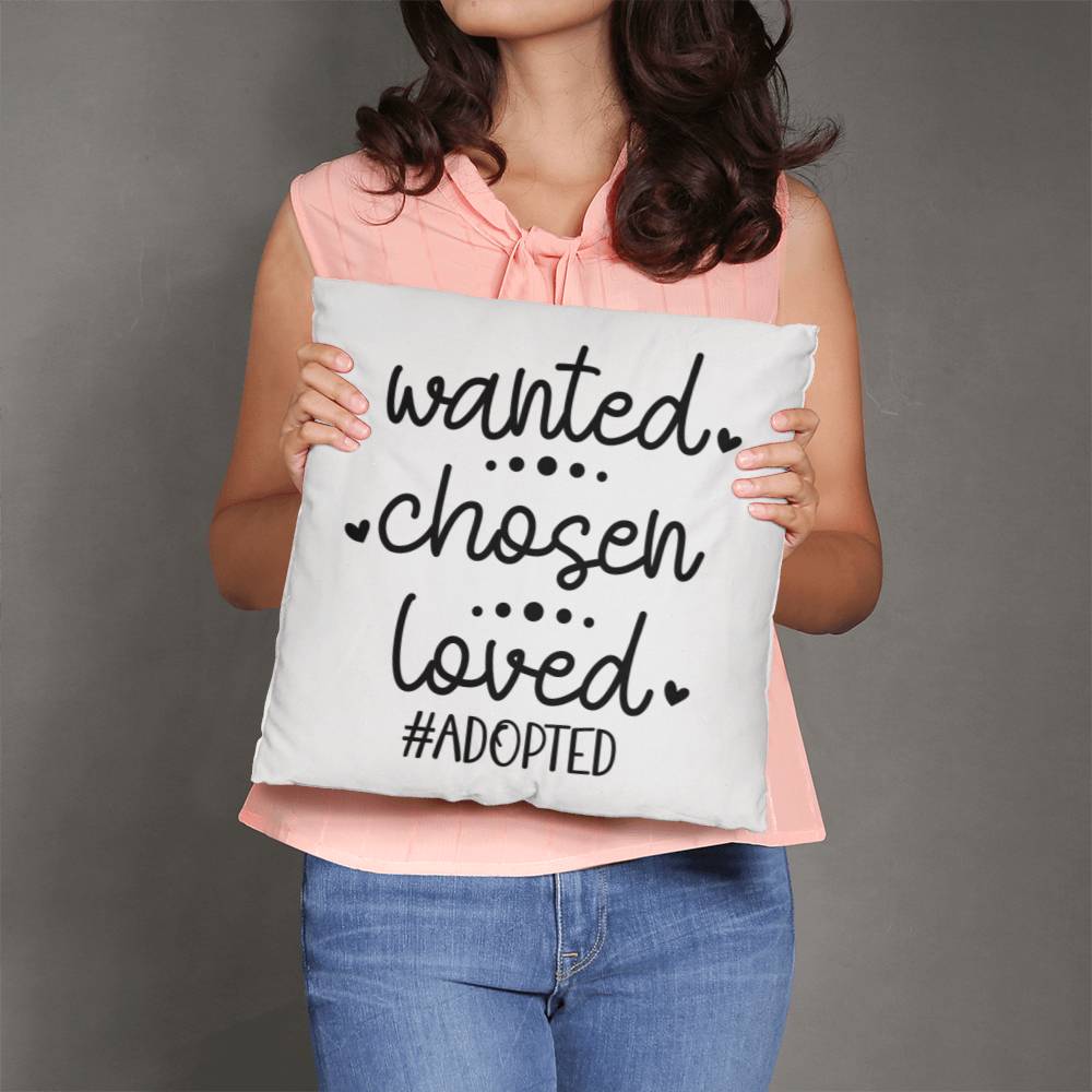 a woman holding a pillow that says wanted chosen loved adopted