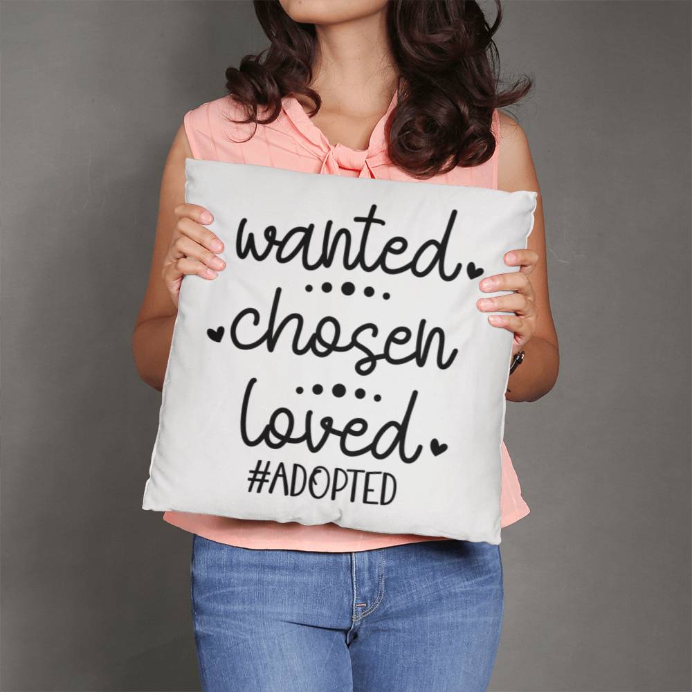 a woman holding a pillow that says wanted chosen loved adopted