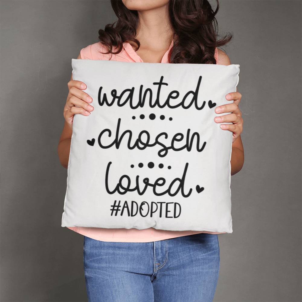 a woman holding a pillow that says wanted chosen loved adopted