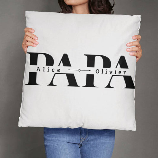 a woman holding up a pillow with the word papa on it