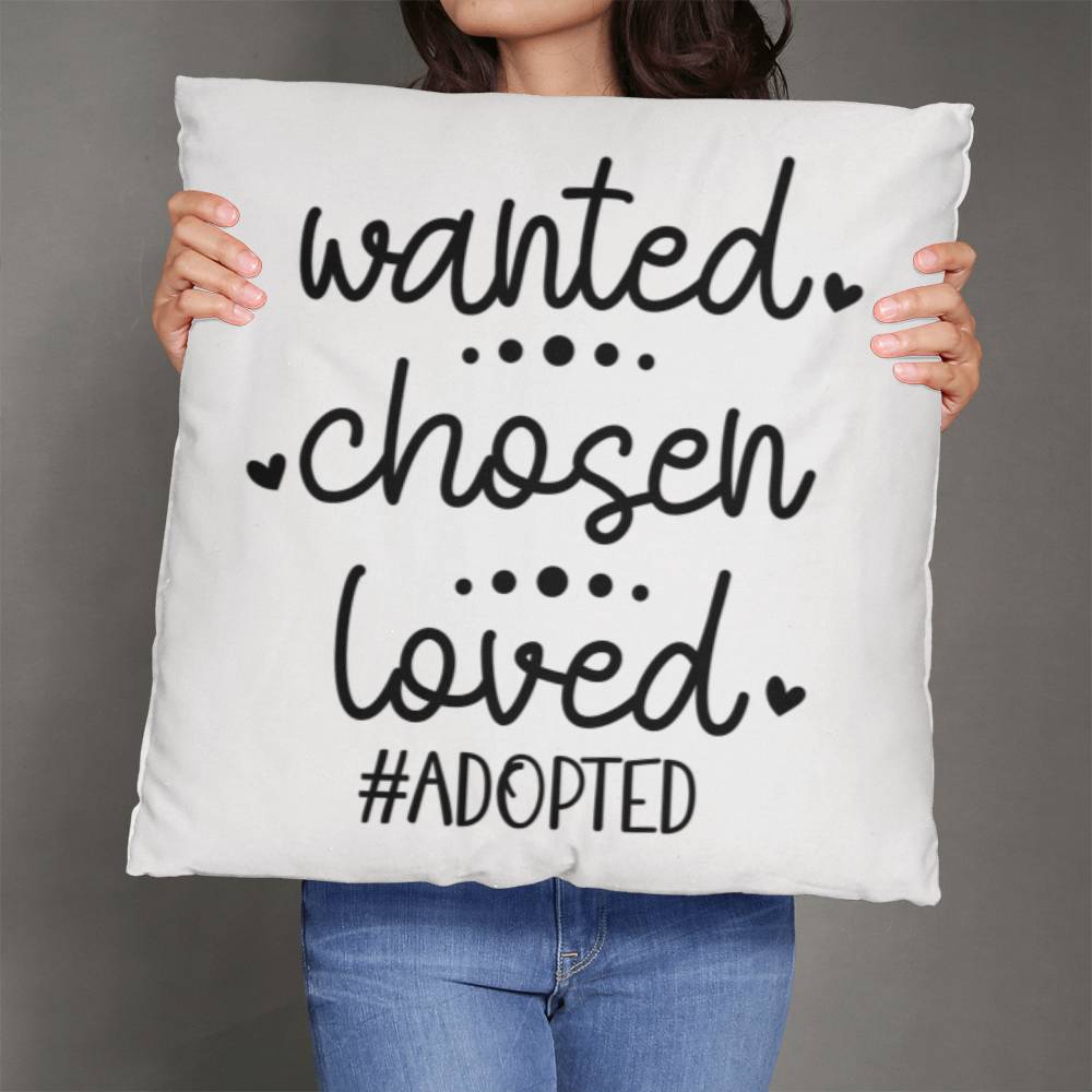 a woman holding a pillow that says wanted chosen loved adopted