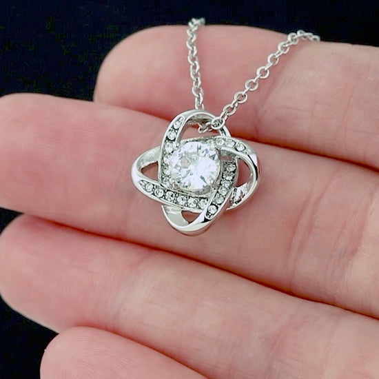 Necklace with an intertwined, sparkling pendant in a gift box for daughter.